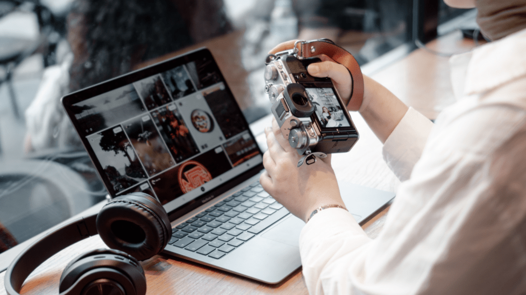 A person is looking at a laptop screen with clothes on it