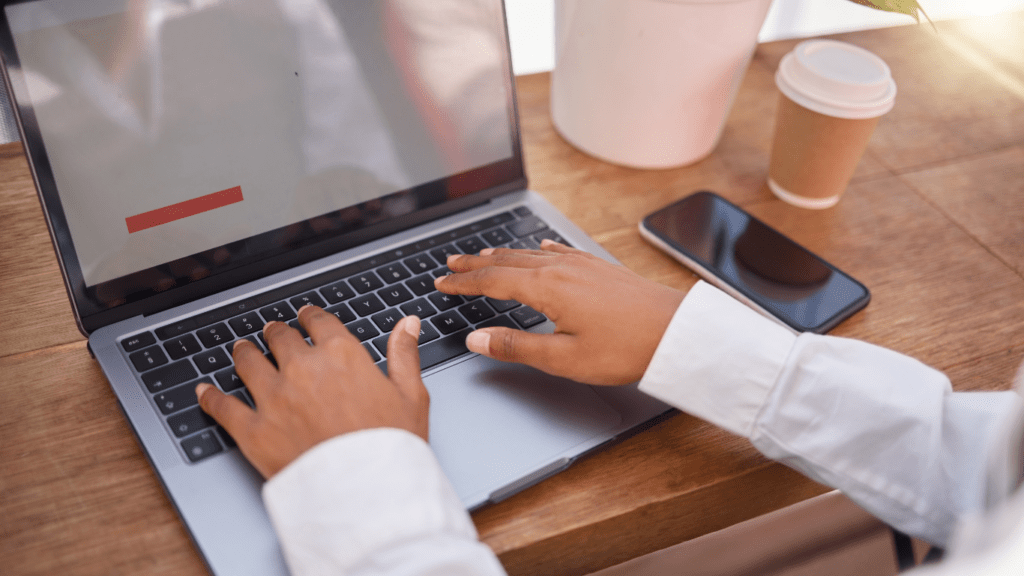 a person typing on a laptop computer