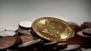 a bitcoin is seen on top of a pile of coins in this undated handout photo