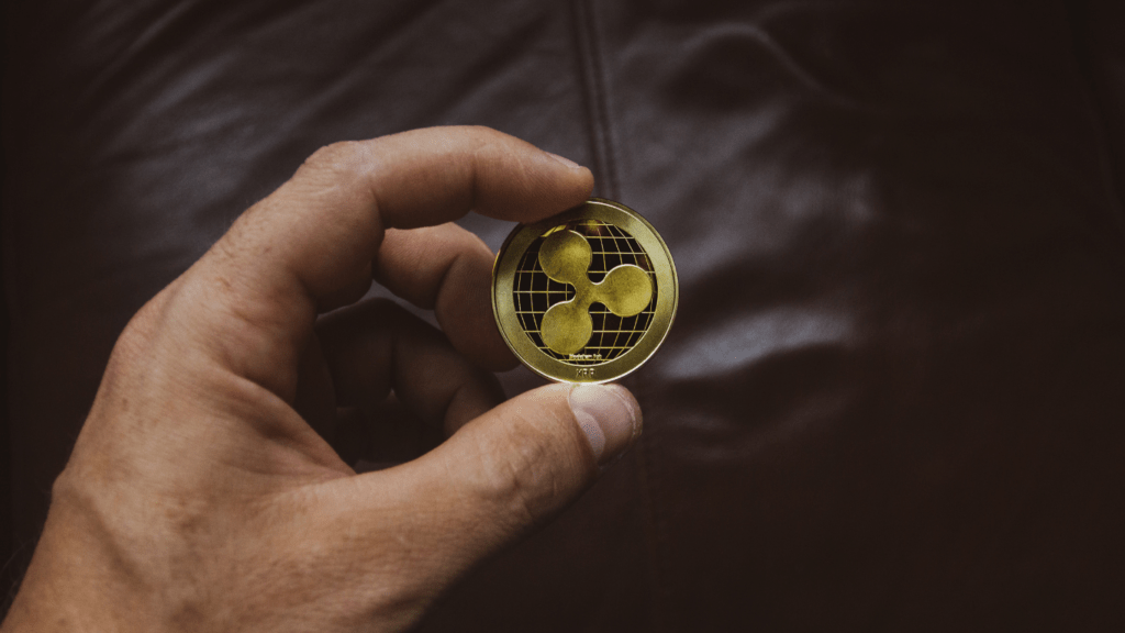 a person holding a gold coin in their hand