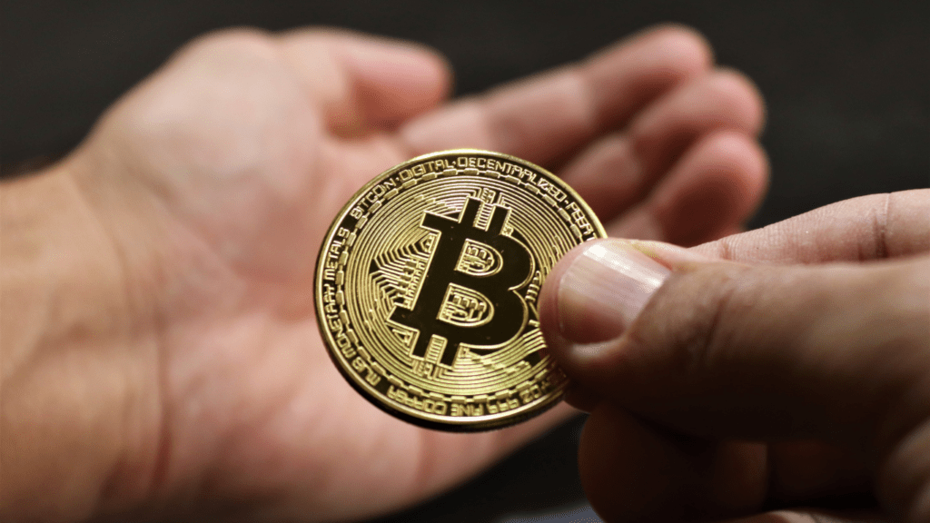 a person holding a bitcoin currency