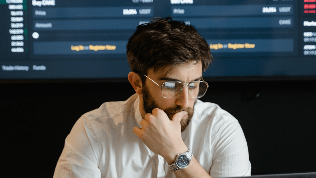 a person in a white shirt sitting at a desk