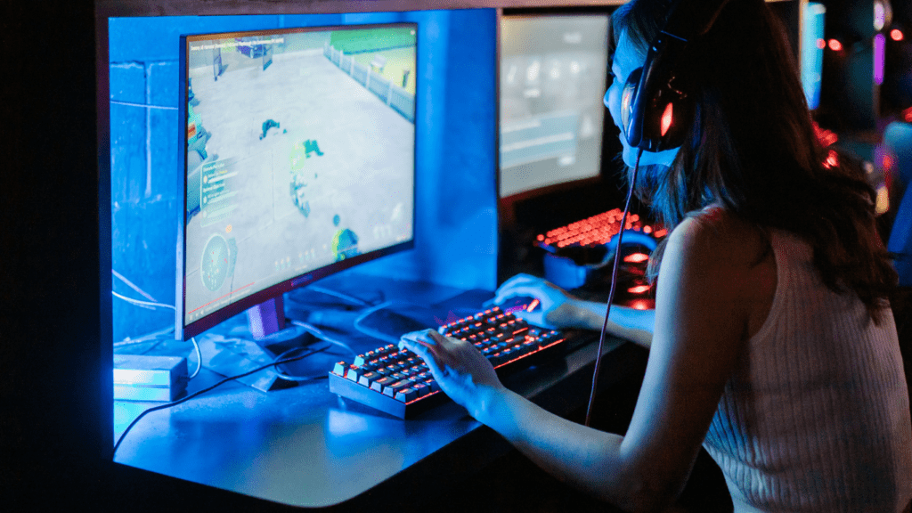 a person is playing video games on two computer screens