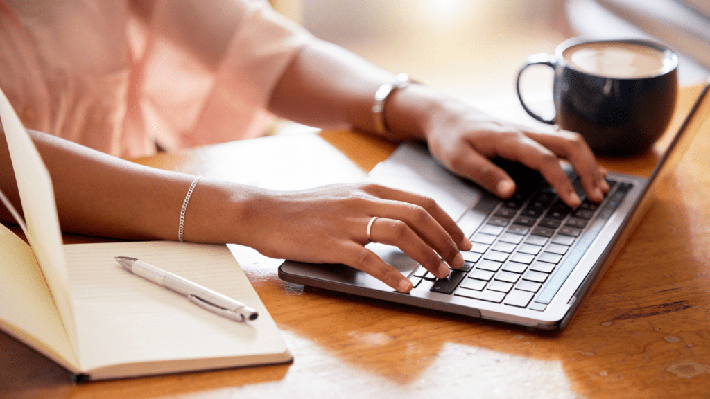 a person typing on a laptop computer