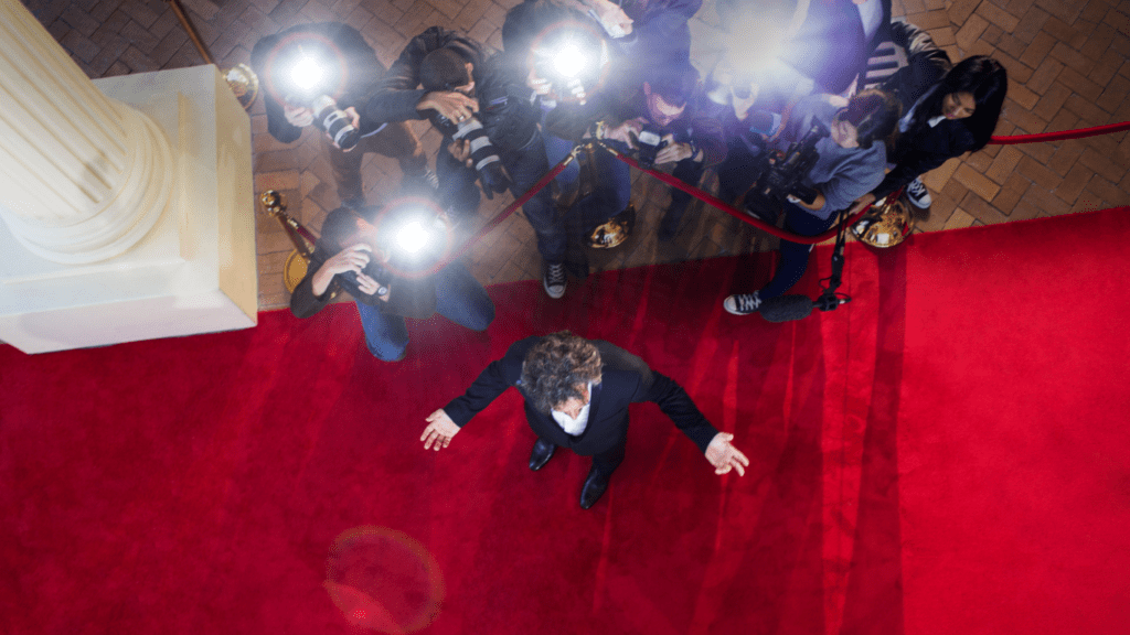 people taking pictures on a red carpet