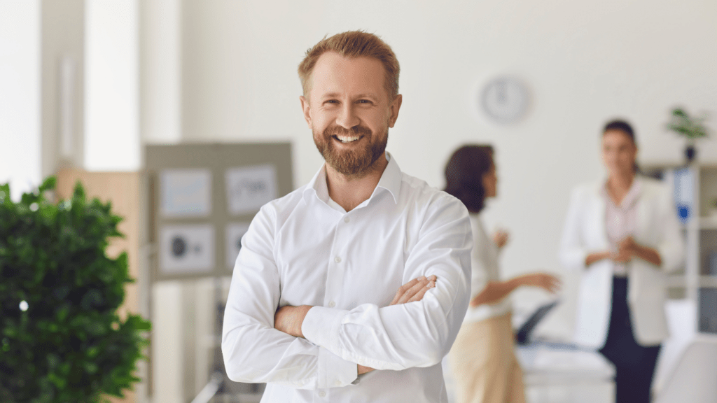 Happy businessman standing in the office