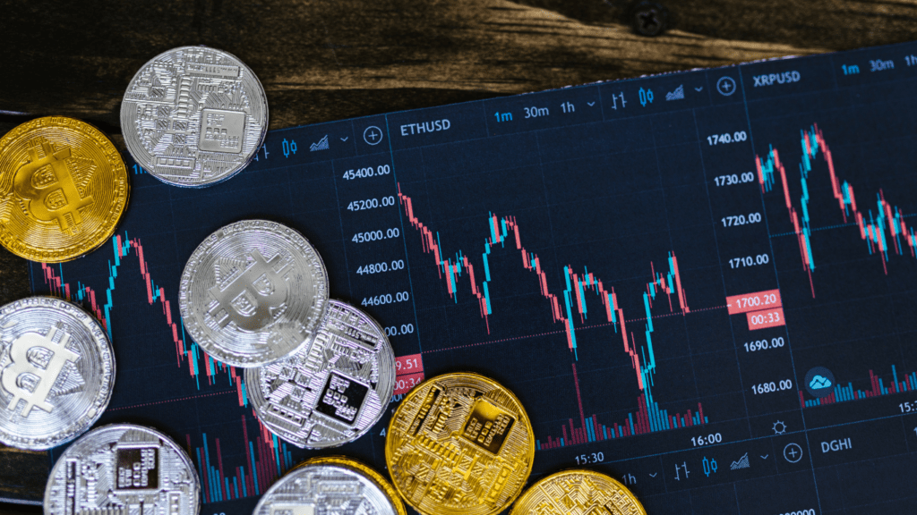 silver and gold coins with trading chart