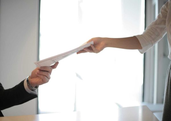 Job Applicant Passing Her Documents